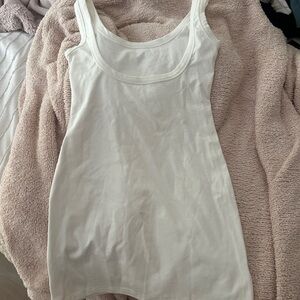 white dress with low cut back, bodycon fitting super stretchy.